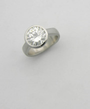 Full bezel minimalist engagement ring with exposed culet