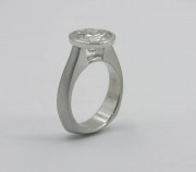 Full bezel minimalist engagement ring with exposed culet