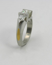 Platinum partial bezel princess cut diamond engagement ring with trillion side stones & 24k inlay