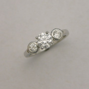 Platinum engagement ring with bezel set side Diamonds